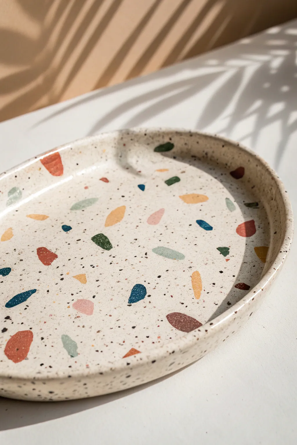 Playful terrazzo speckles on a minimalist platter for an easy, modern statement piece.
