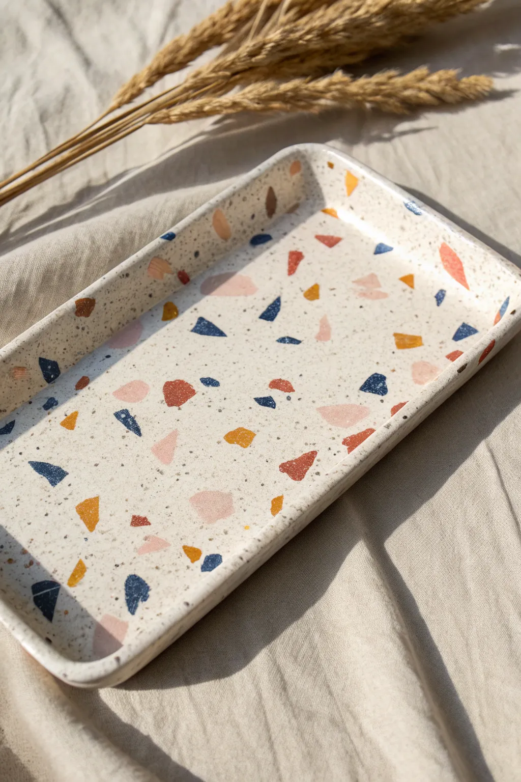 Terrazzo speckle ceramic tray on linen, minimalist boho accent for jewelry or keys.