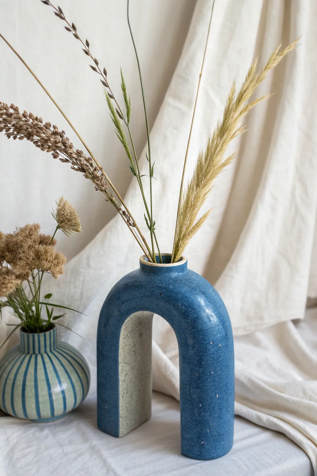 U-shaped arch vase with asymmetrical stems for minimal ikebana vibes and bold modern contrast