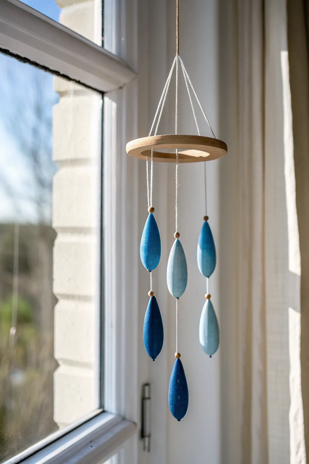 Ombré ceramic teardrops in bold indigo to sky blue, glowing in bright natural light.