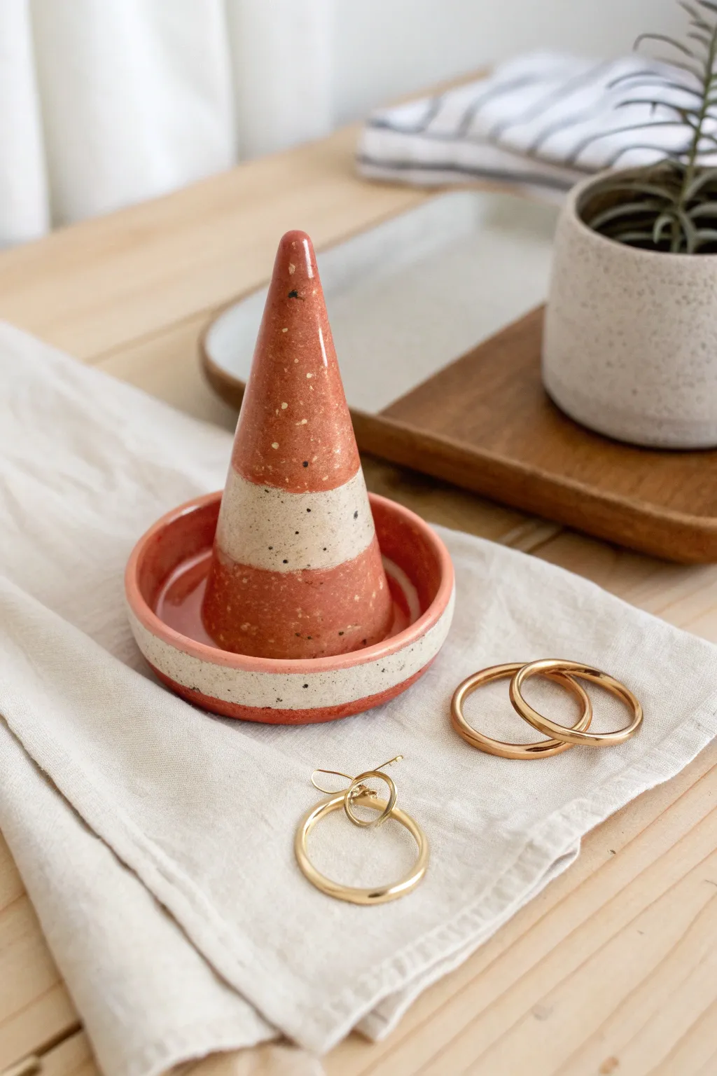 Bold glazed ring cone with matching catch-all dish, a minimalist vanity setup for everyday jewelry.