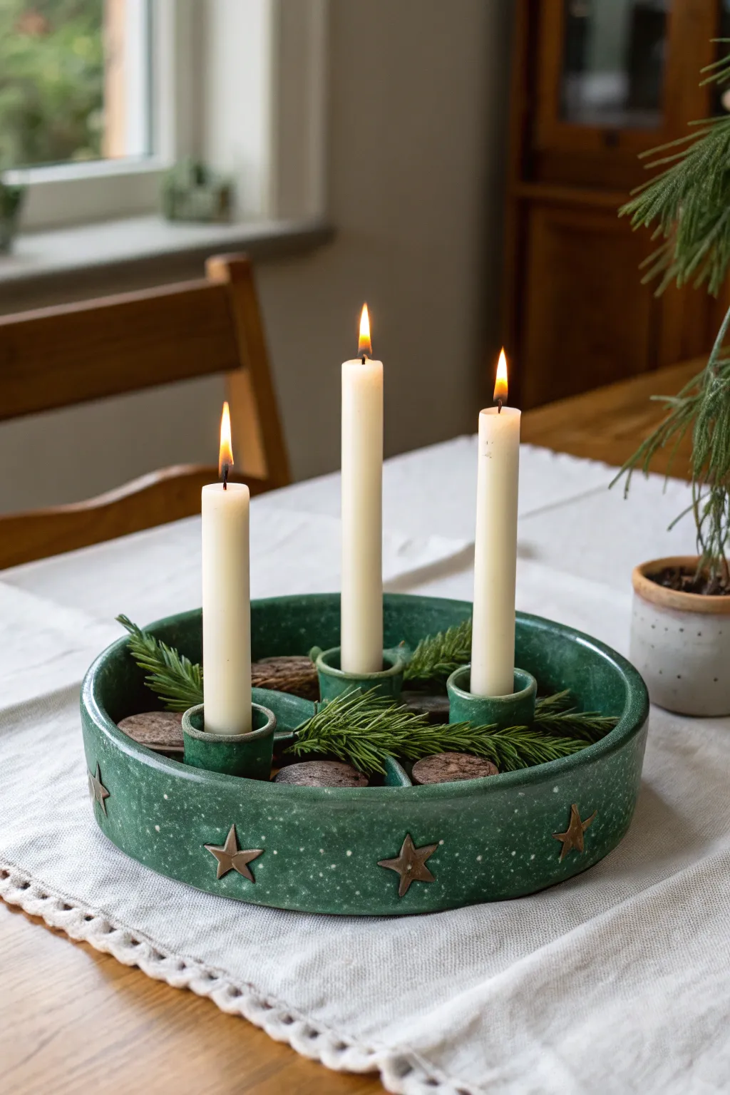 Deep green handmade ceramic candle holder adds Nordic minimal charm to a festive Christmas table