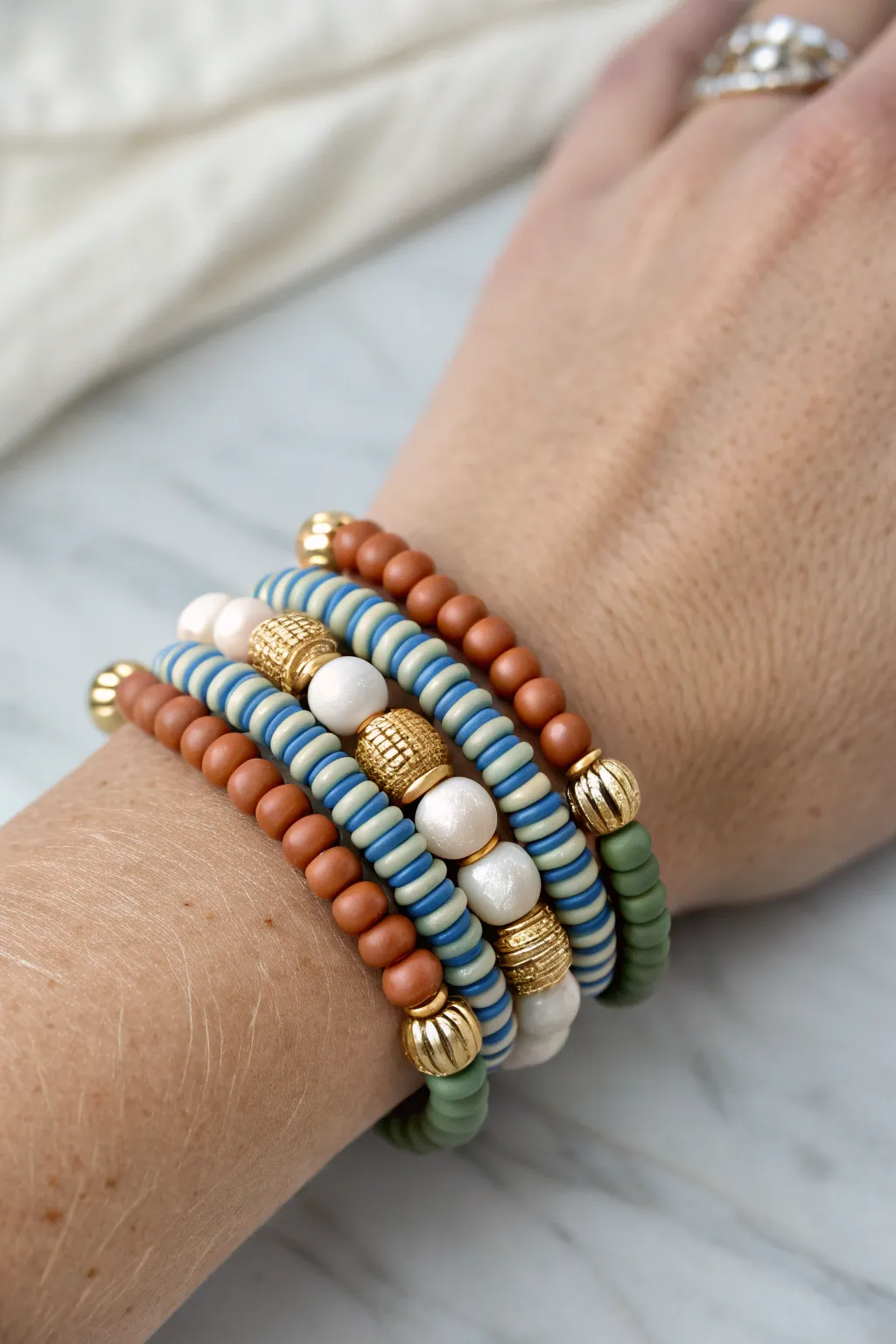 Stripes, solids, and a touch of shine: an easy clay bead stack that looks effortlessly curated.