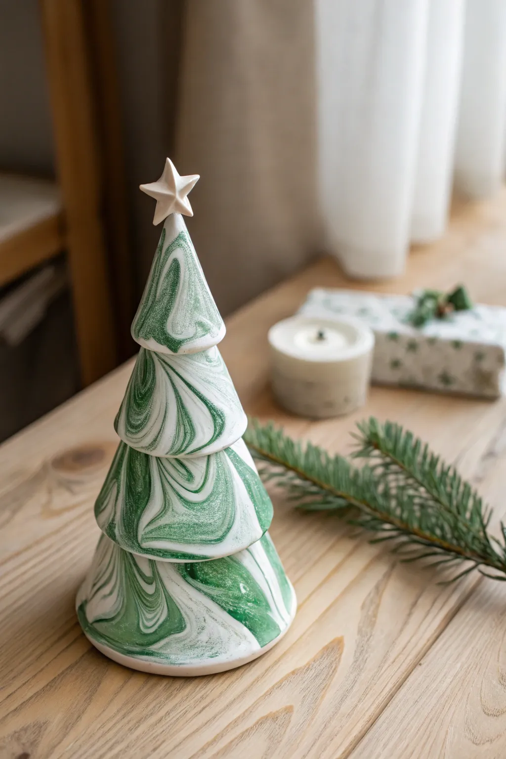 Marbled clay Christmas tree in bold holiday swirls, Scandinavian minimalism, tiny star on top