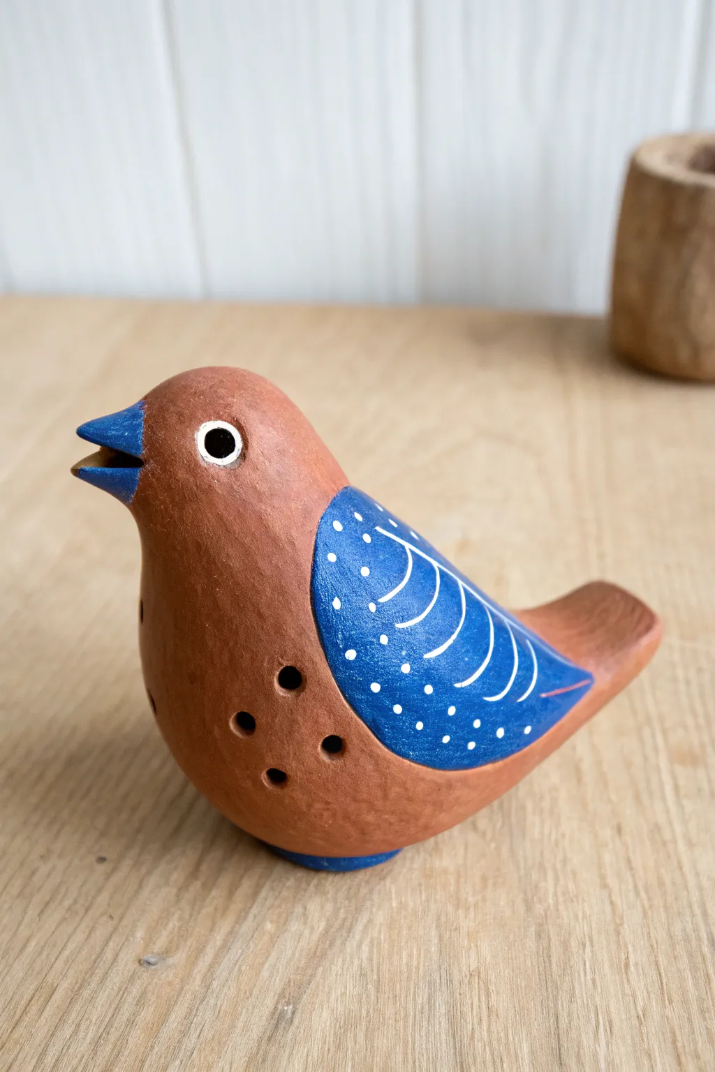 Simple bird clay whistle sculpture with bold painted accents, minimalist and boho, ready to display