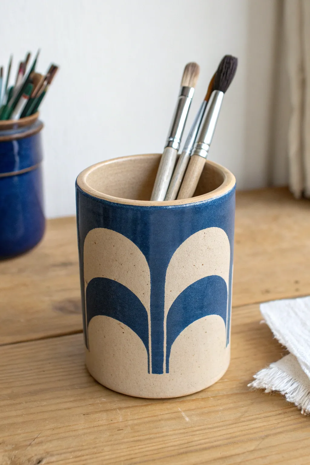 Matte clay pen cup with bold cutouts in a minimalist Scandi style, easy and striking.