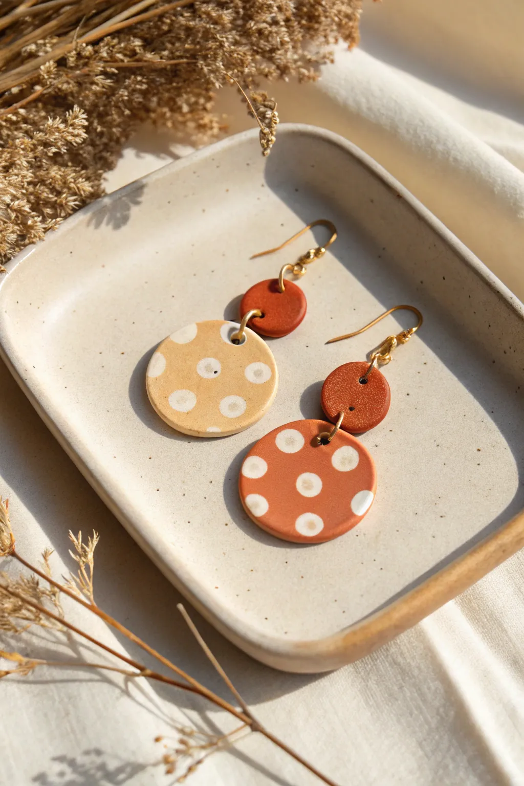 Beginner-friendly polka dot clay earrings: bold and subtle pairs in a clean minimalist flat lay.