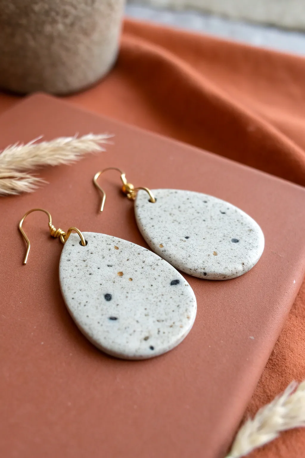 Speckled granite-look clay earrings with clean Scandinavian styling and cozy boho warmth.