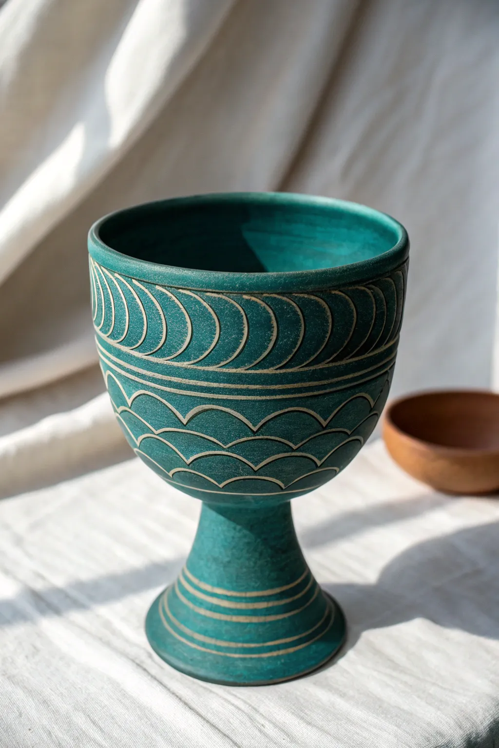 Simple sgraffito waves on a handmade goblet, bold slip and calm Nordic styling.