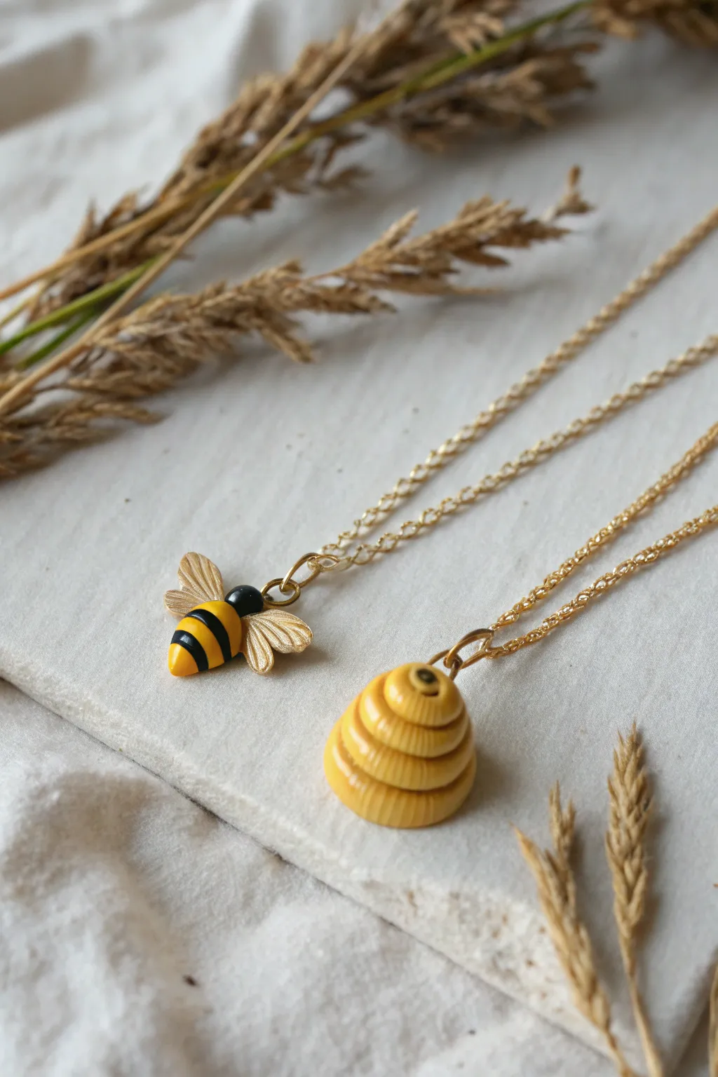 Sweet bee and hive charm duo in sunny yellow, handcrafted clay details on matching chains.