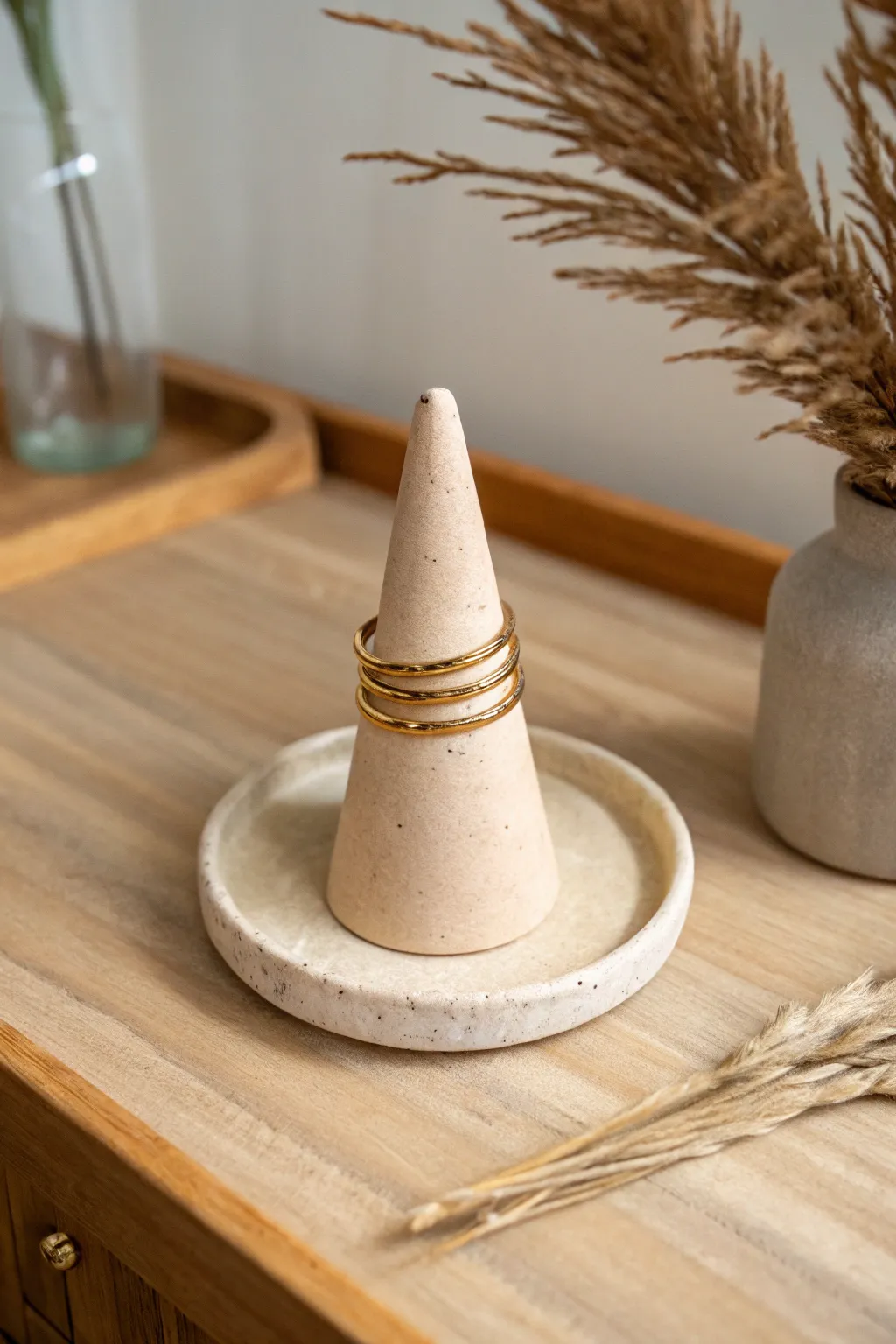 Simple clay ring cone on a tiny dish base, warm minimal styling and bold terracotta contrast