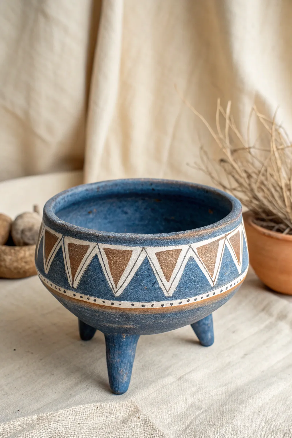 Tripod pinch pot vessel with bold carving and matte cobalt glaze, perfect for high school clay.