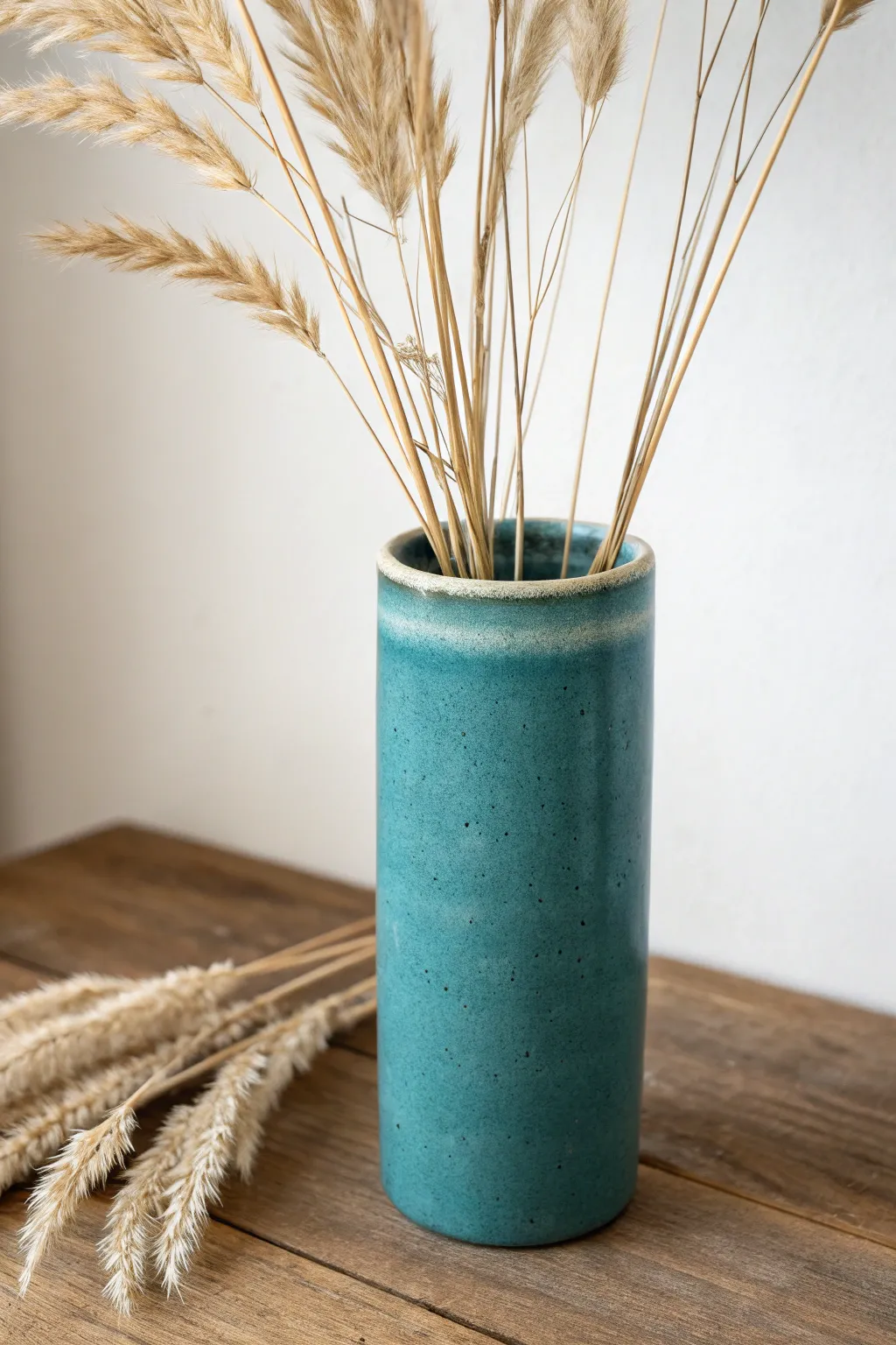 Beginner slab cylinder vase with a matte glaze and simple dried stems, minimal and beautifully handmade.