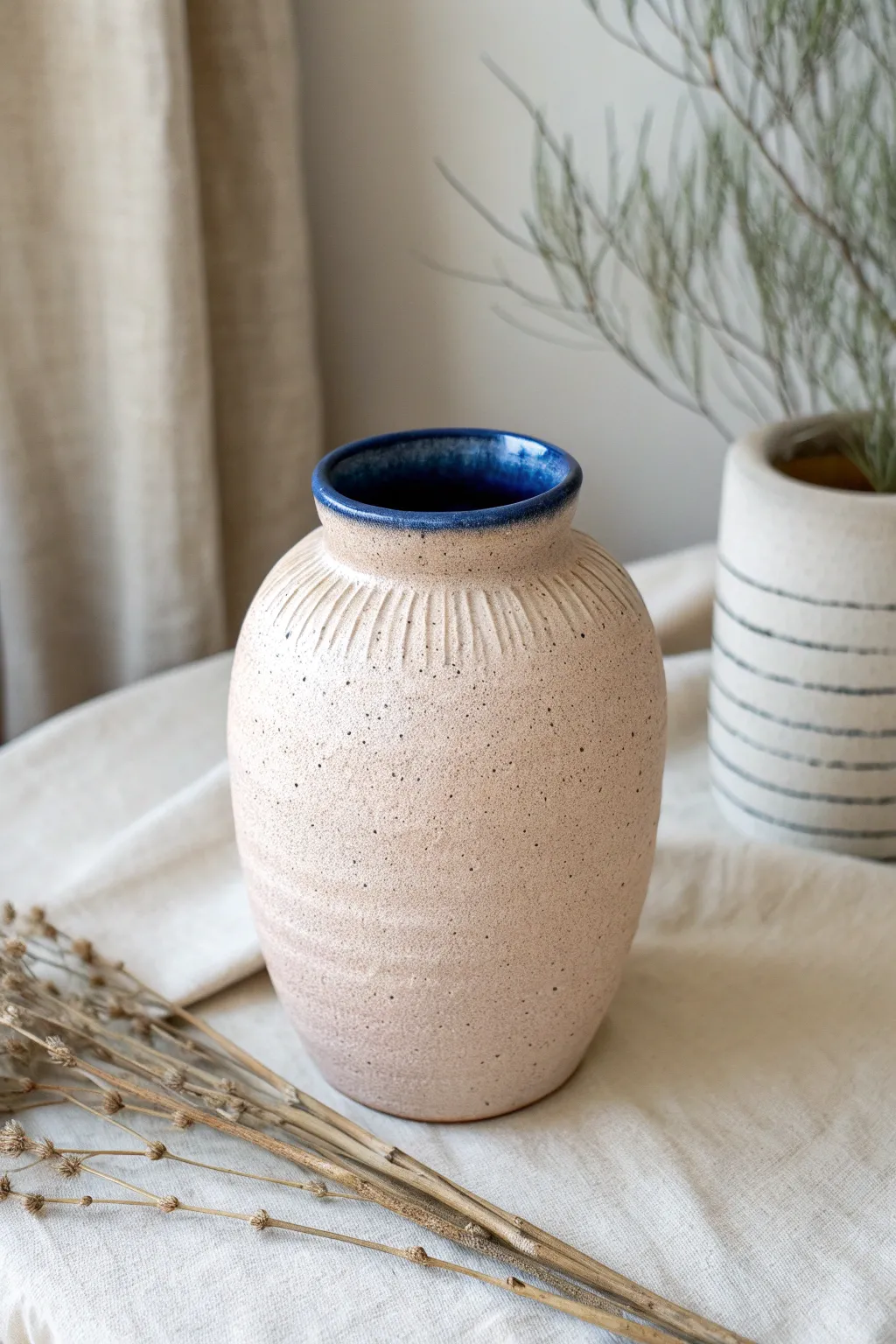 Slab-built vase with all-over pressed texture and bold cobalt rim, minimal Nordic-boho styling.