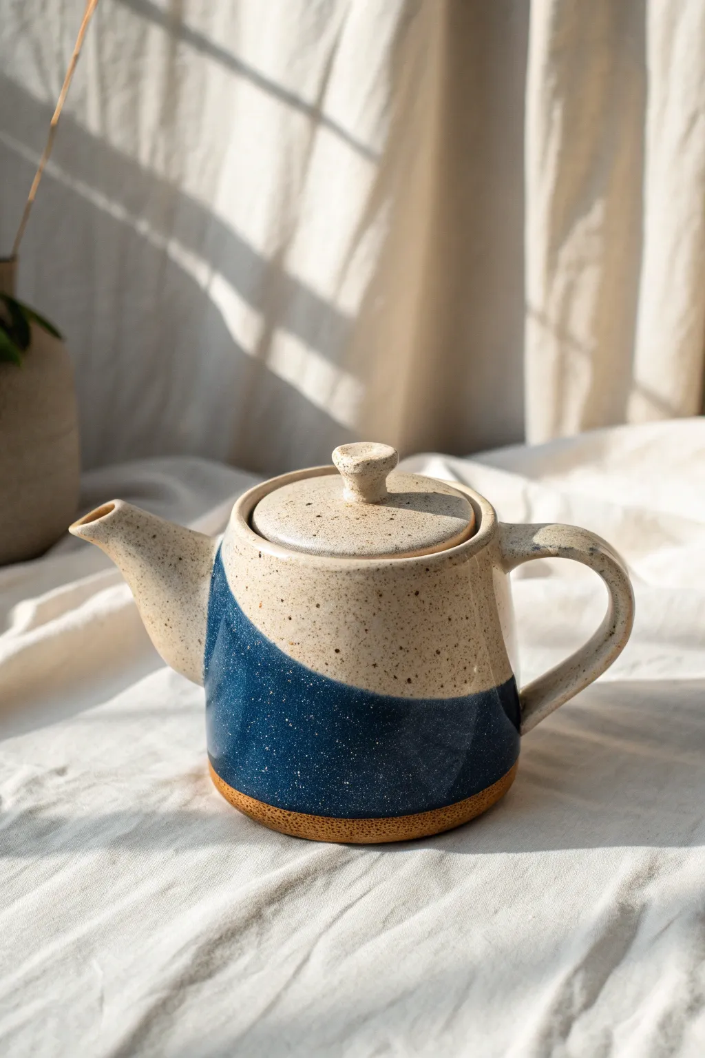 Modern two-tone dipped glaze teapot with bold cobalt base and soft ivory top, minimalist charm.