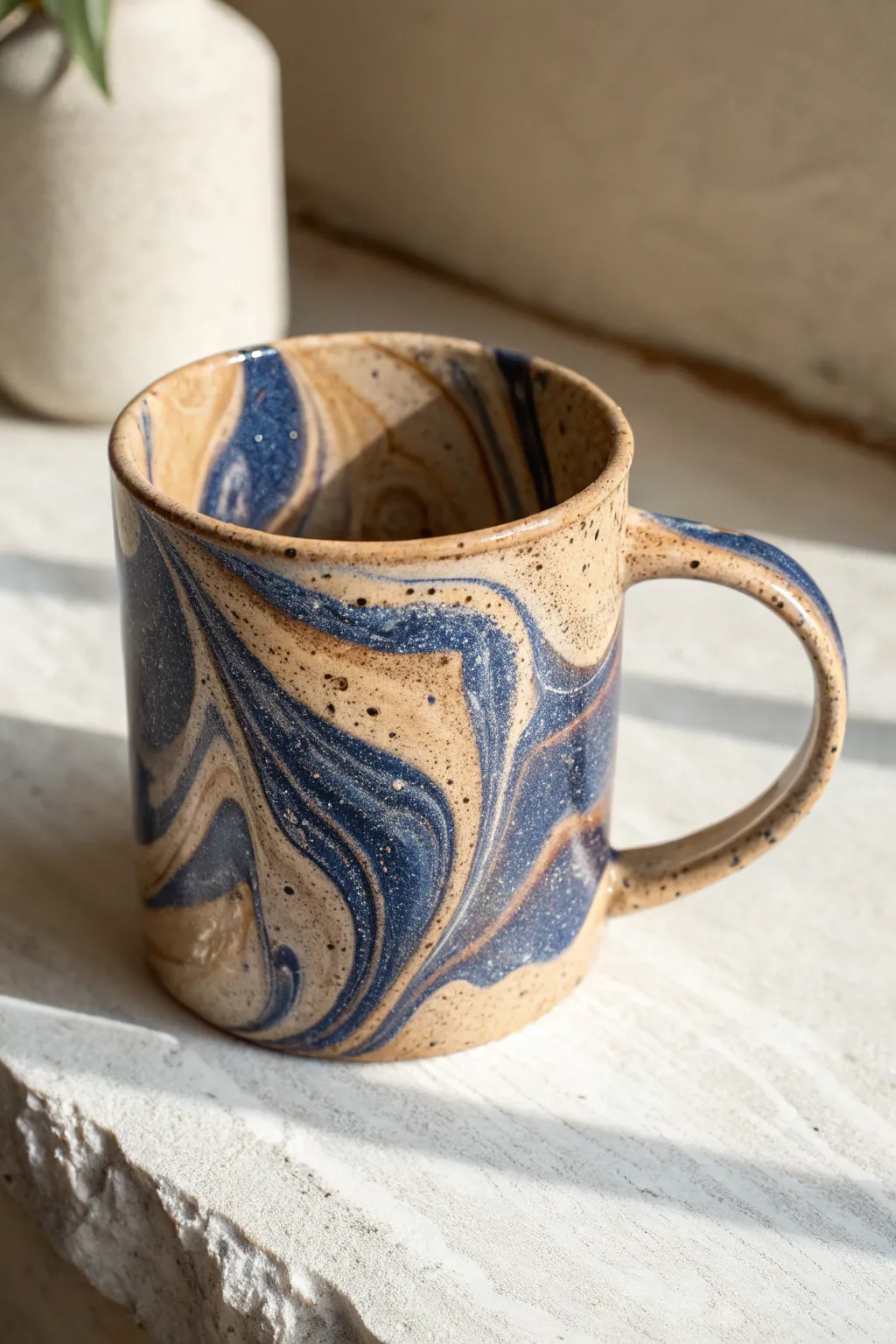 Marbled glaze mug with stone-like swirls in bold, calming tones for minimalist clay inspo