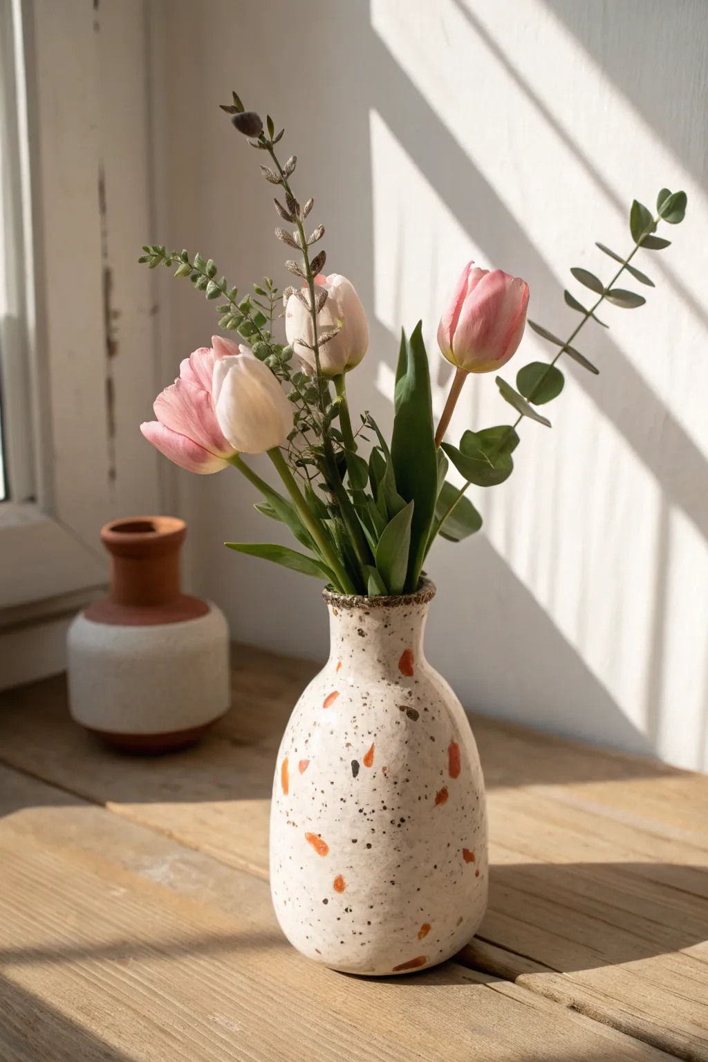Terrazzo speckled mini vase with soft blooms, a sweet handmade Mothers Day gift idea.