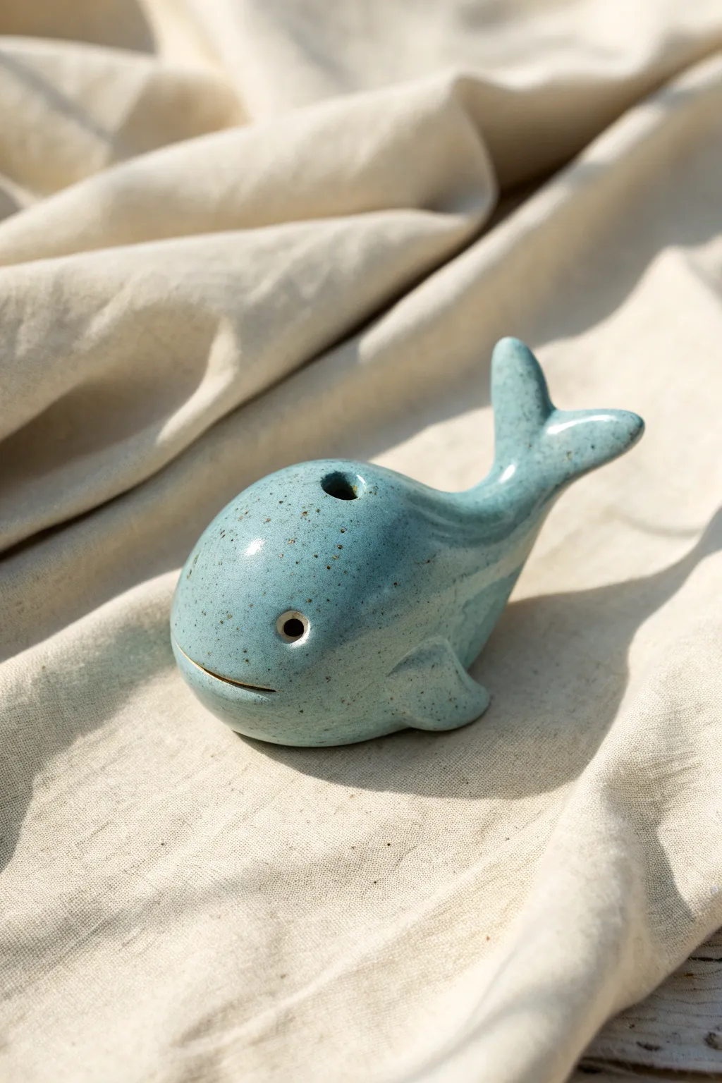 Tiny whale bubble rattle in calm blue glaze, minimal boho charm, perfect beginner clay project.