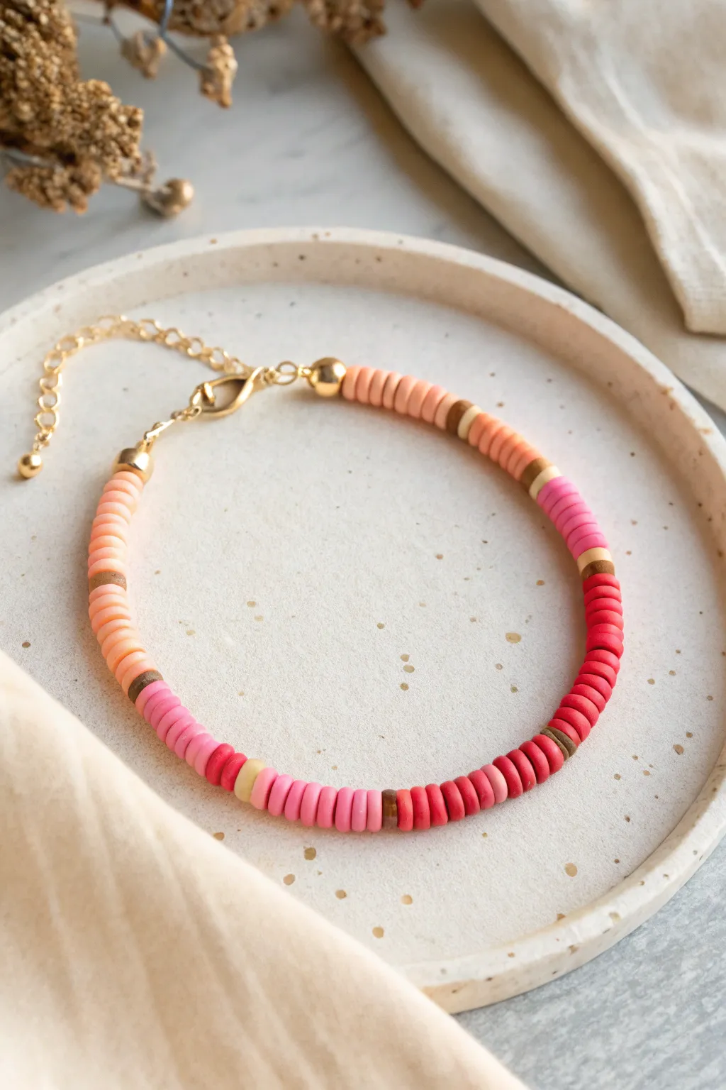 Ombre sunset clay disc bead bracelet, from peach to hot pink to deep coral in a smooth fade.