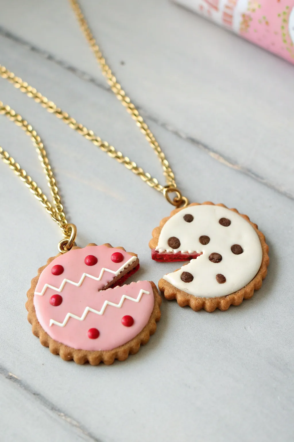 Best friends split cookie pendants in soft pastels, minimalist boho styling, bold contrast.