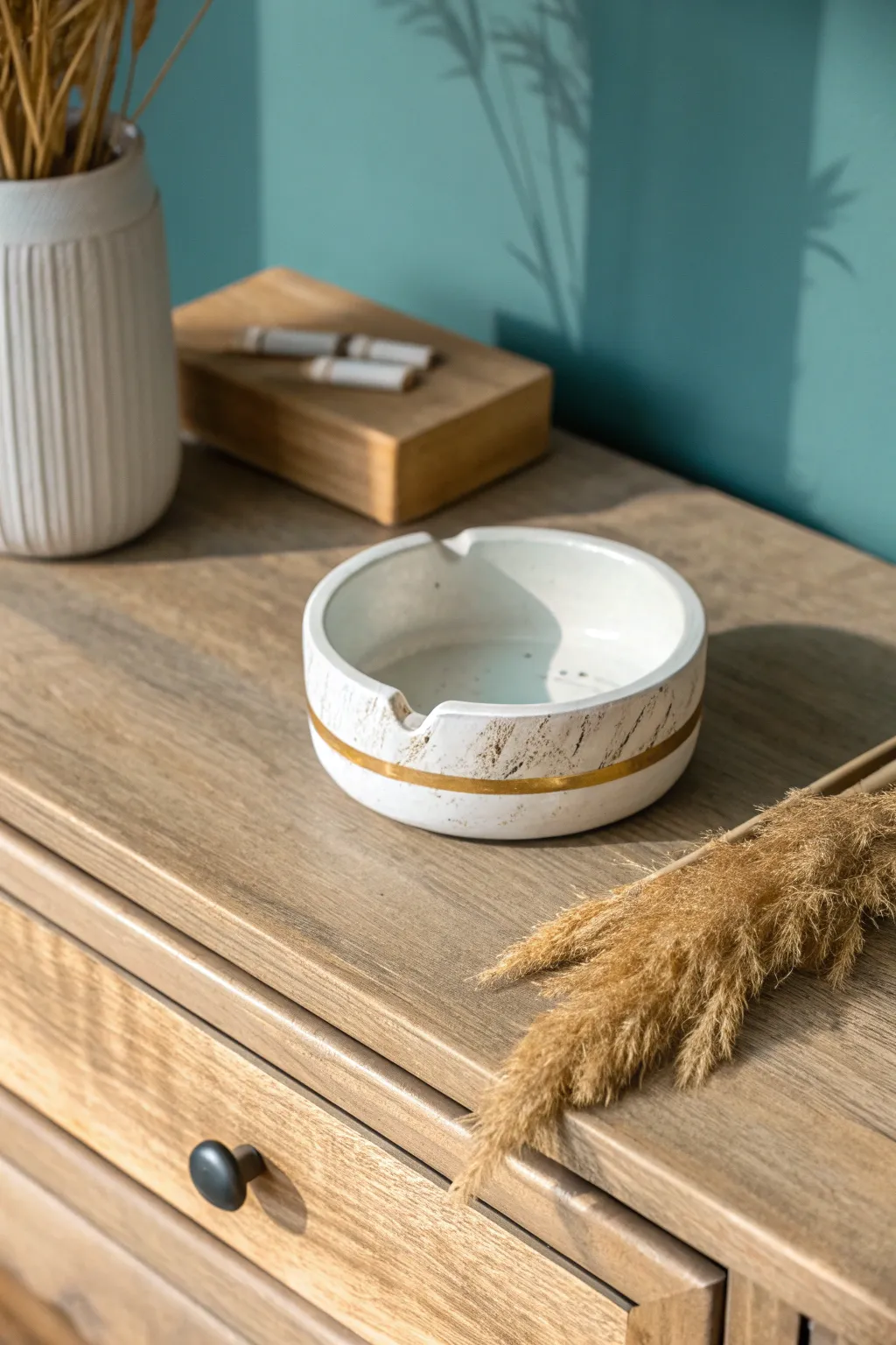 Minimal DIY clay ashtray with a sleek gold rim, modern rests, and bold Scandinavian contrast