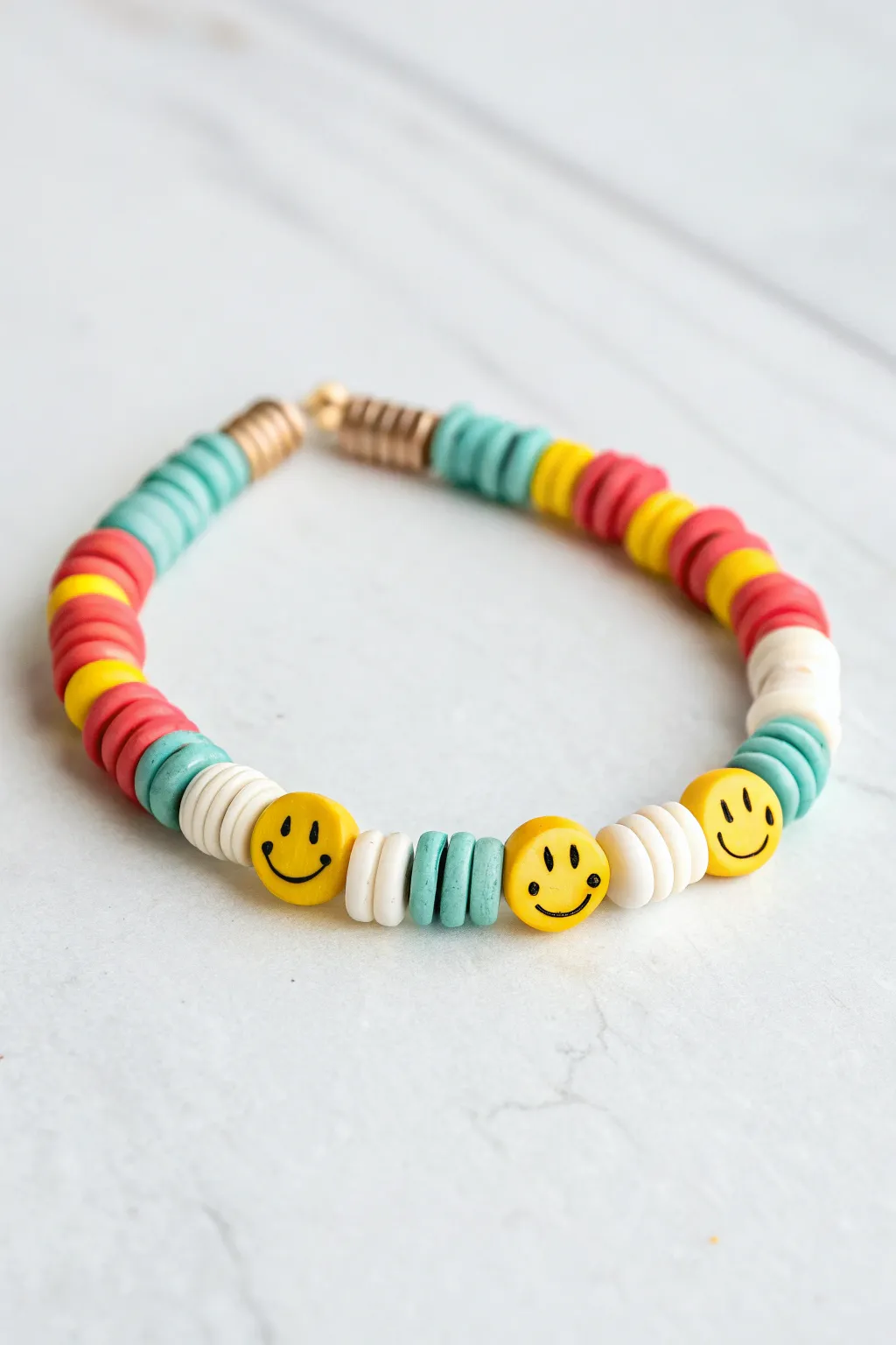 Smiley accents + bright clay discs make this easy bracelet feel happy, modern, and handmade.
