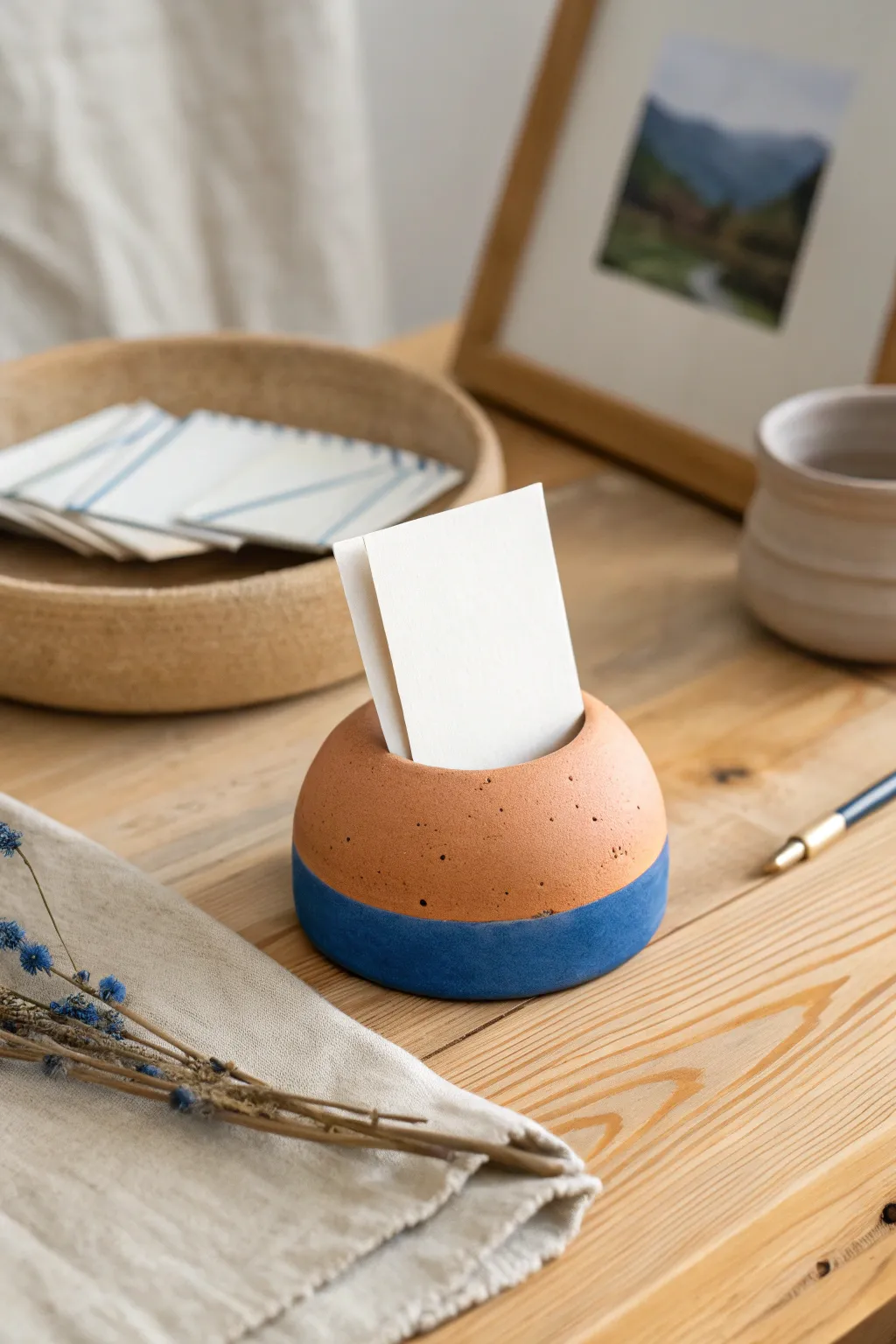Minimal clay card stand in terracotta and cobalt, a chic DIY desk accent with clean contrast.