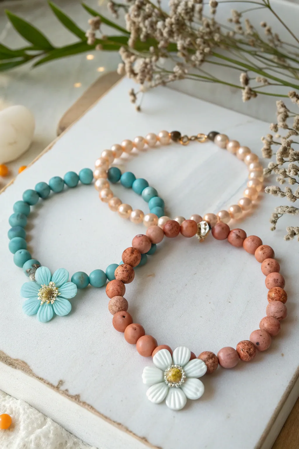 Birth month colorway clay bead flower bracelets in cool, warm, and neutral Scandinavian palettes.