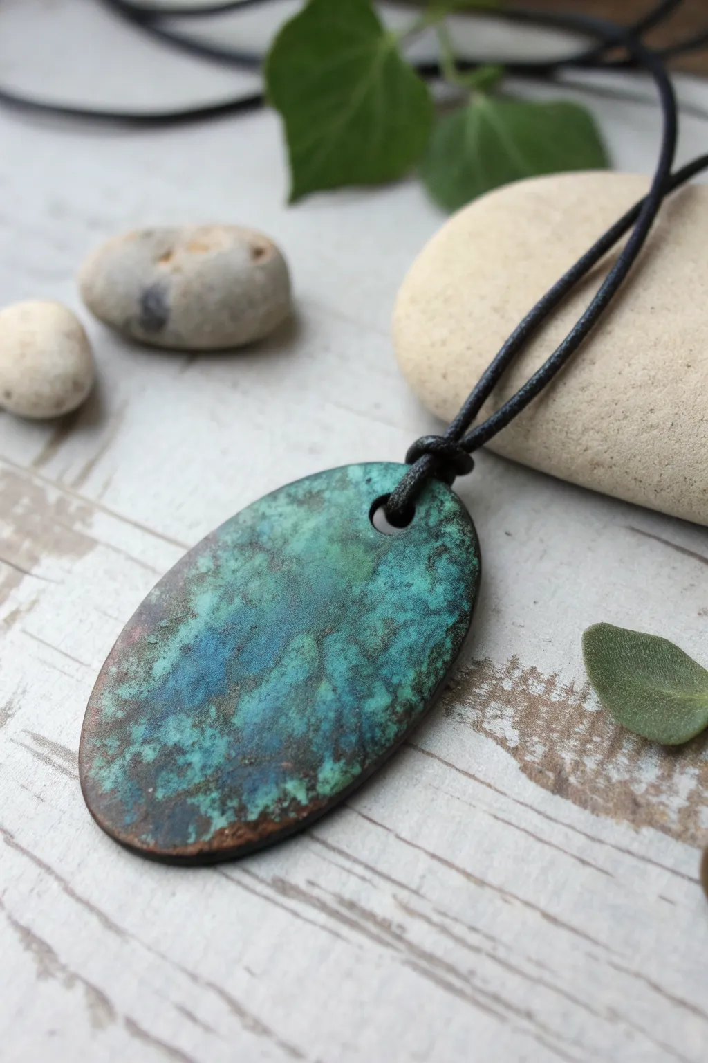 Verdigris patina pendant with deep teal blooms, minimalist styling and grunge relic charm.