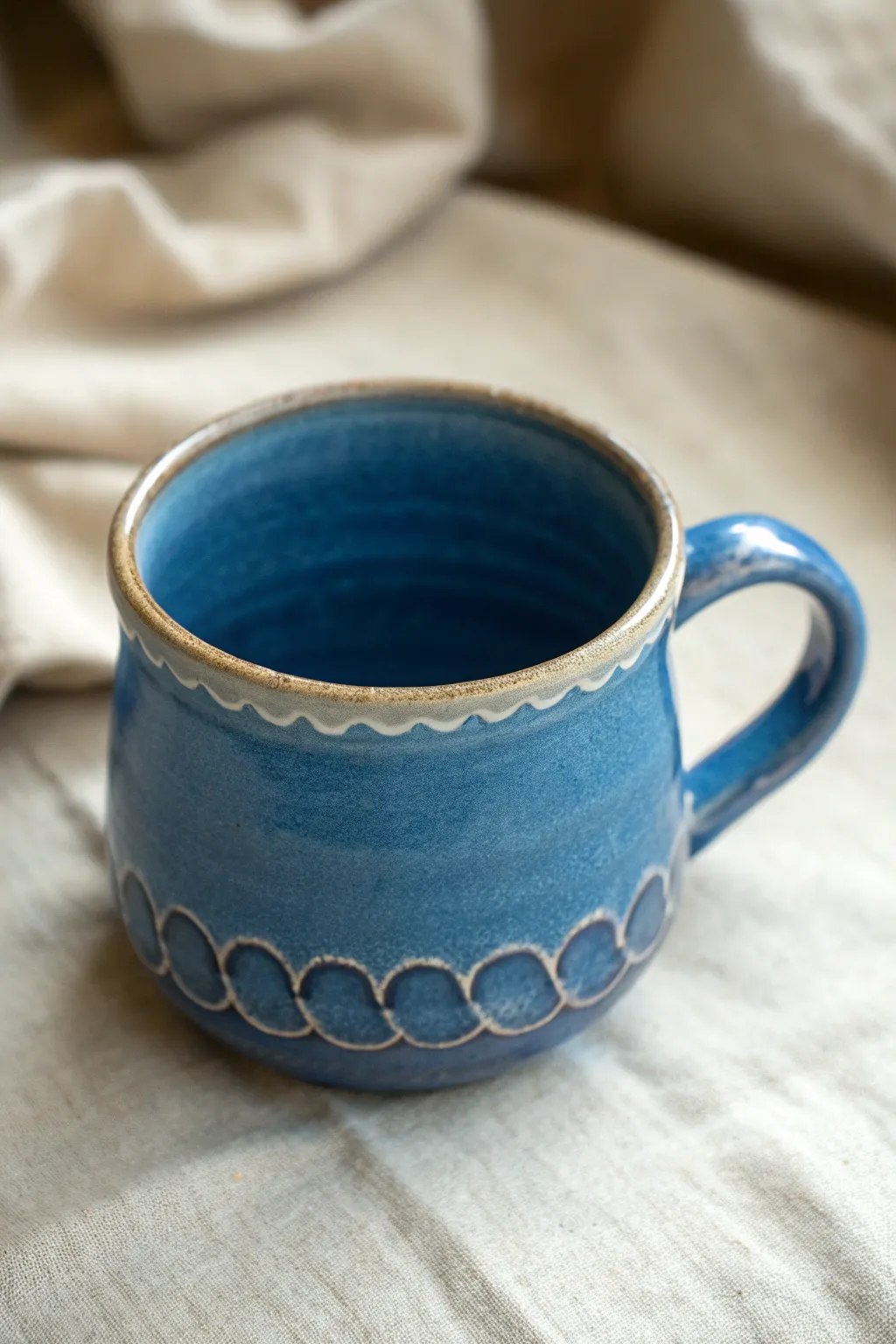 Scalloped rim tea mug in bold cobalt glaze, minimalist shape with a soft boho touch.