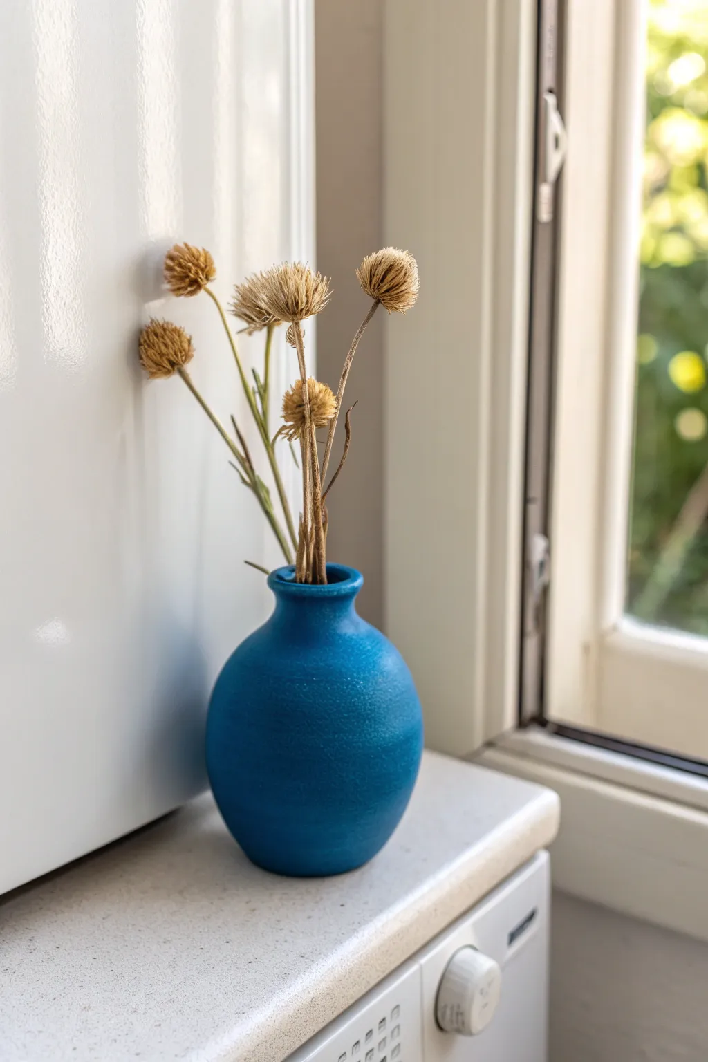 Magnetic mini clay vase: a charming pop of color for tiny dried blooms on your fridge.