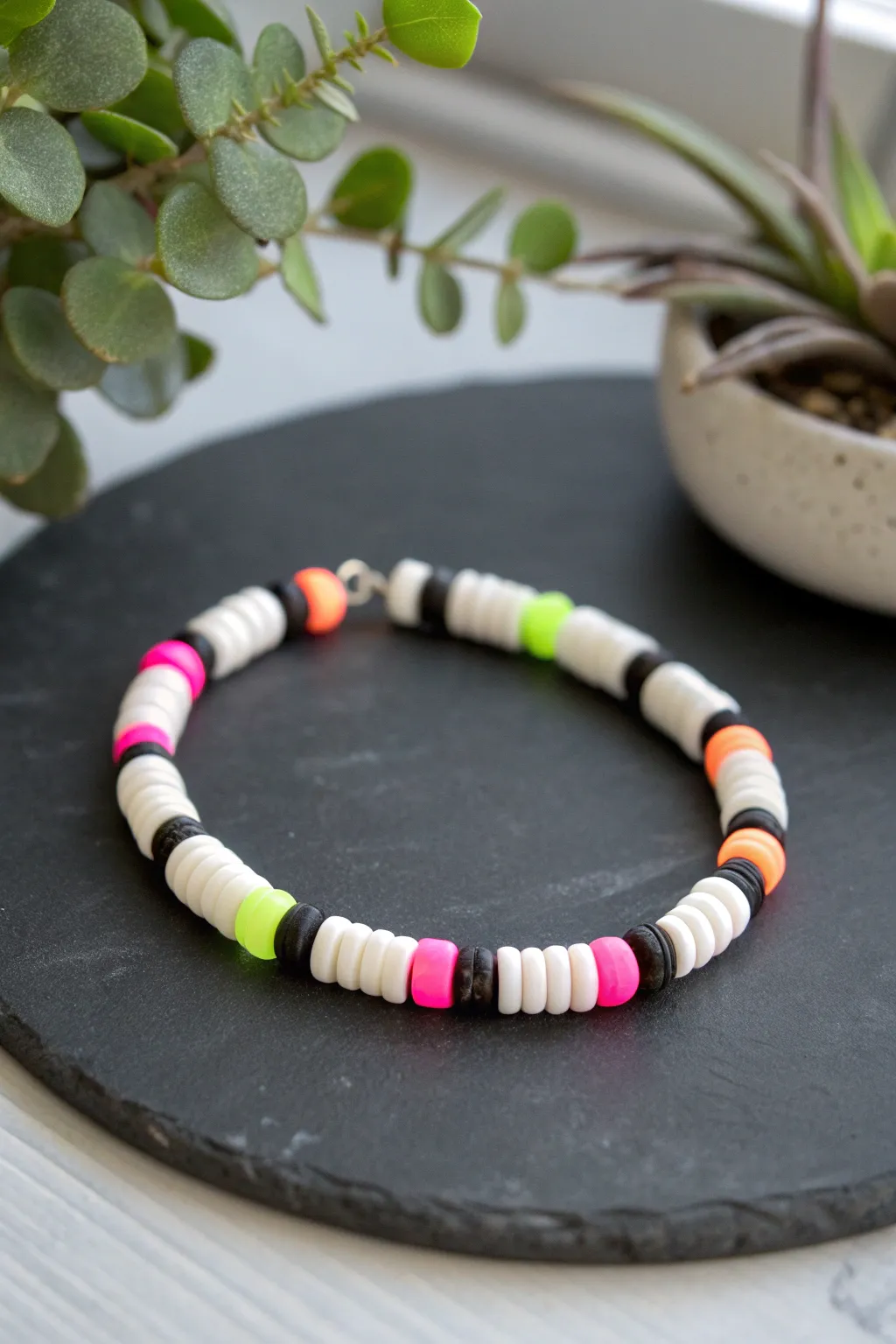 Black and white heishi bracelet with neon pops, a simple kids DIY that looks boldly modern