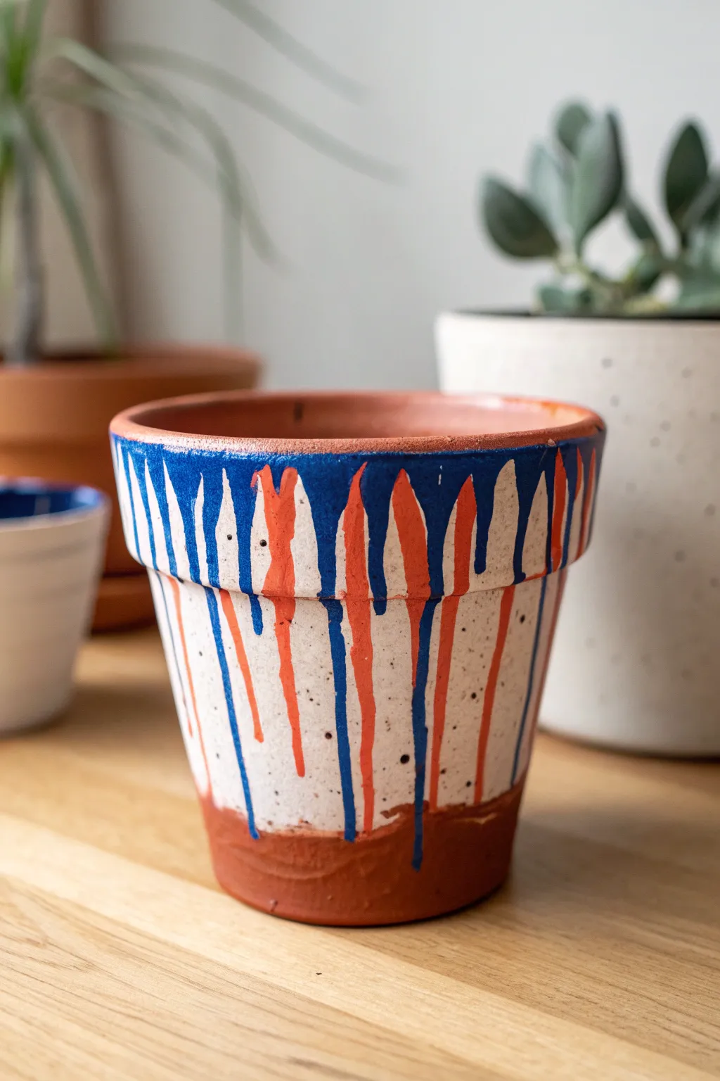 Bold drip-painted mini terracotta pot that turns a simple planter into instant abstract art.