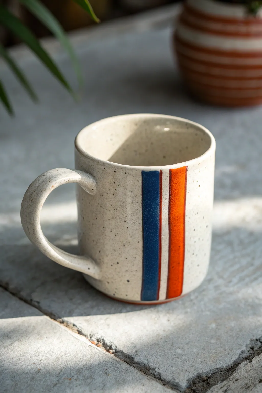 Retro racing stripes that wrap the handle for a clean, bold mug painting idea for guys.