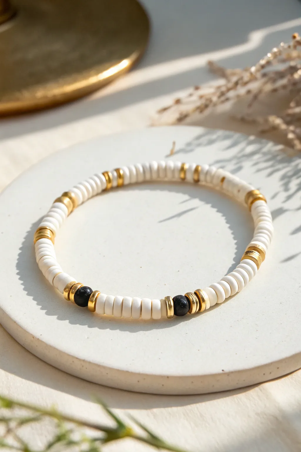 White clay heishi bracelet with slim gold spacer lines for a chic New Year glow