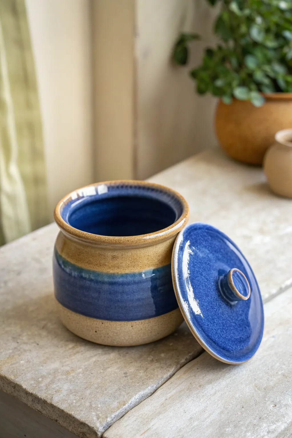 Matte sand exterior, glossy cobalt interior, a simple pinch pot jar that pops on your shelf.