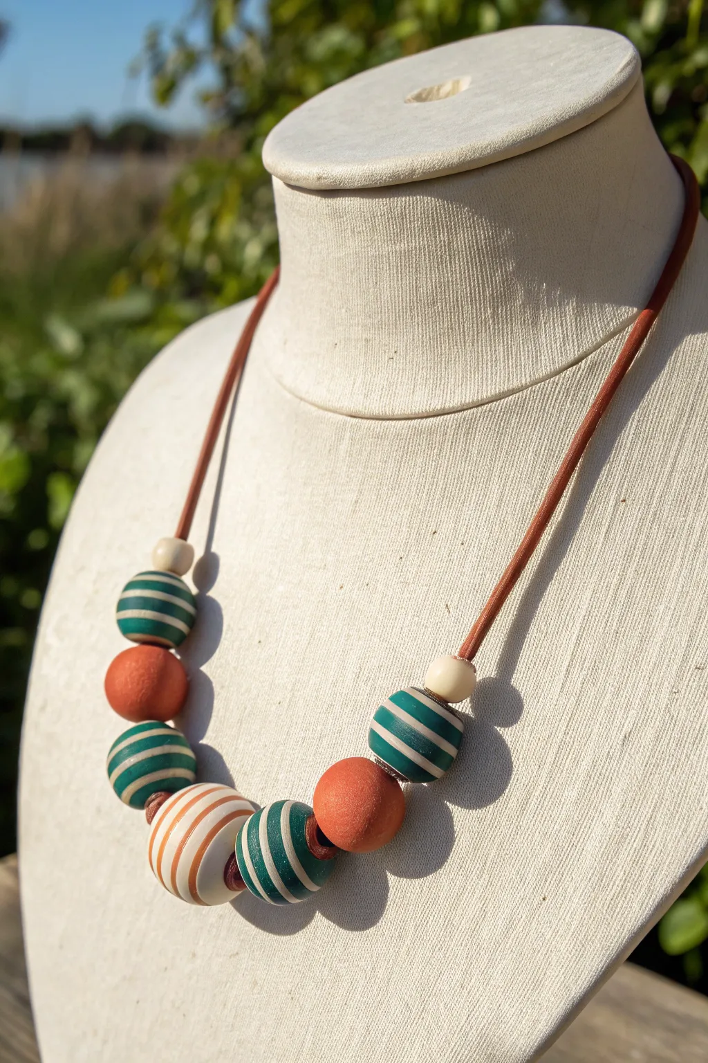 Chunky striped polymer clay tube beads in bold colors for a clean, modern statement necklace.