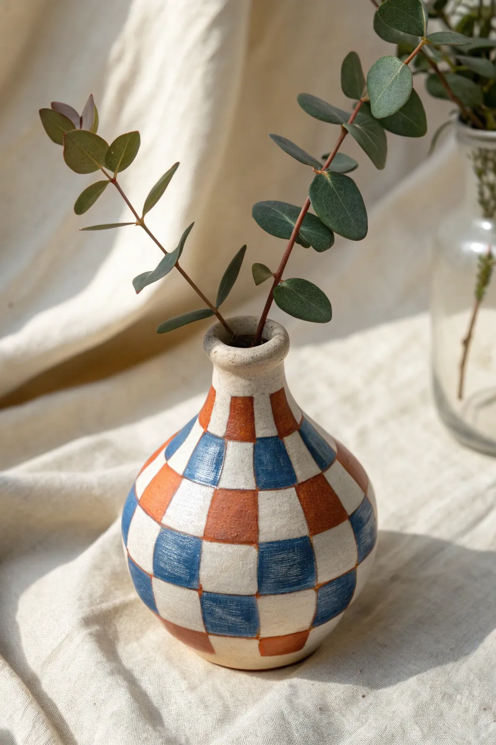 Mini polymer clay bud vase with bold color-wrap pattern, perfect for a sweet handmade birthday gift.