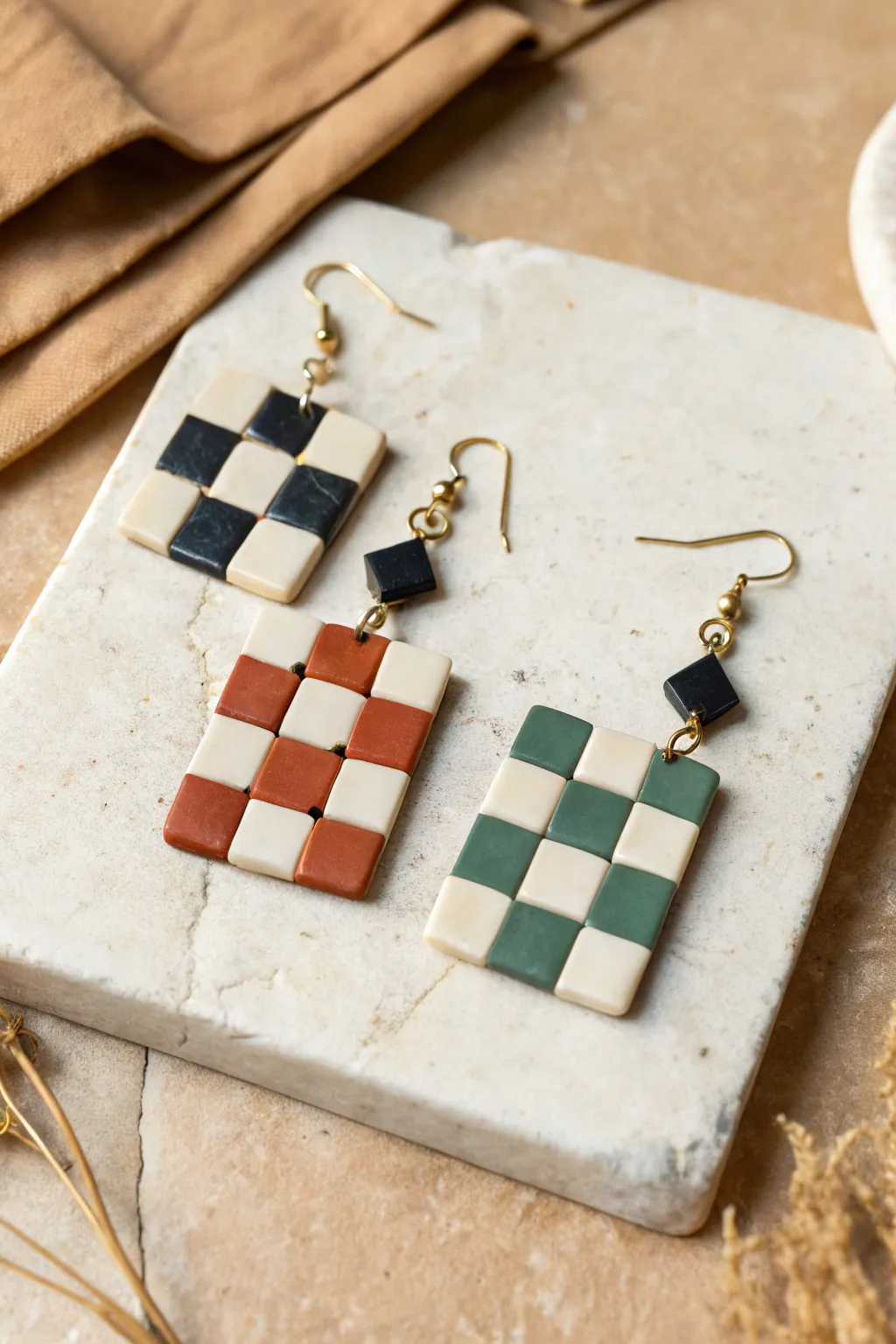 Playful checkerboard polymer clay earrings in bold two-color sets, minimal styling, big contrast.