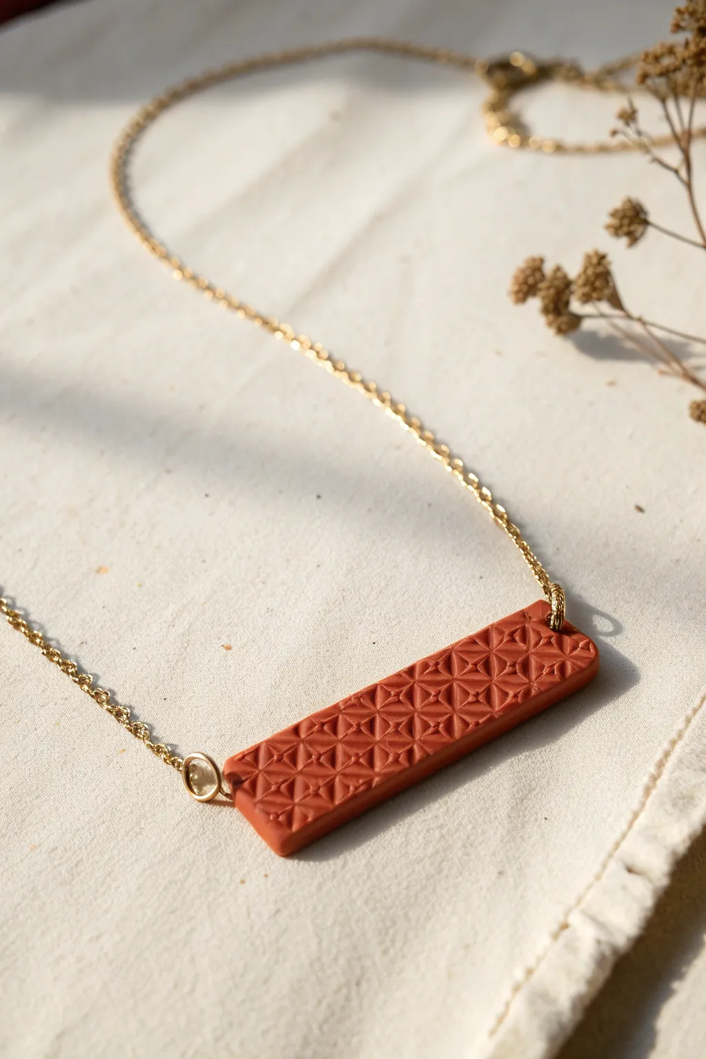 Minimal stamped polymer clay bar necklace in bold terracotta with clean Scandinavian boho contrast