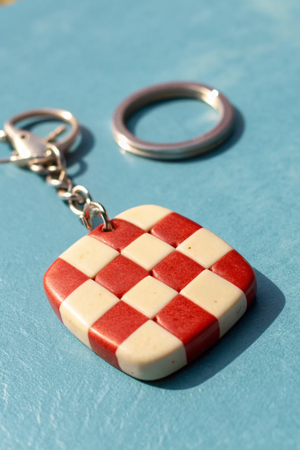 Bold two-tone checkerboard polymer clay keychain charm, minimalist and striking on bright color.