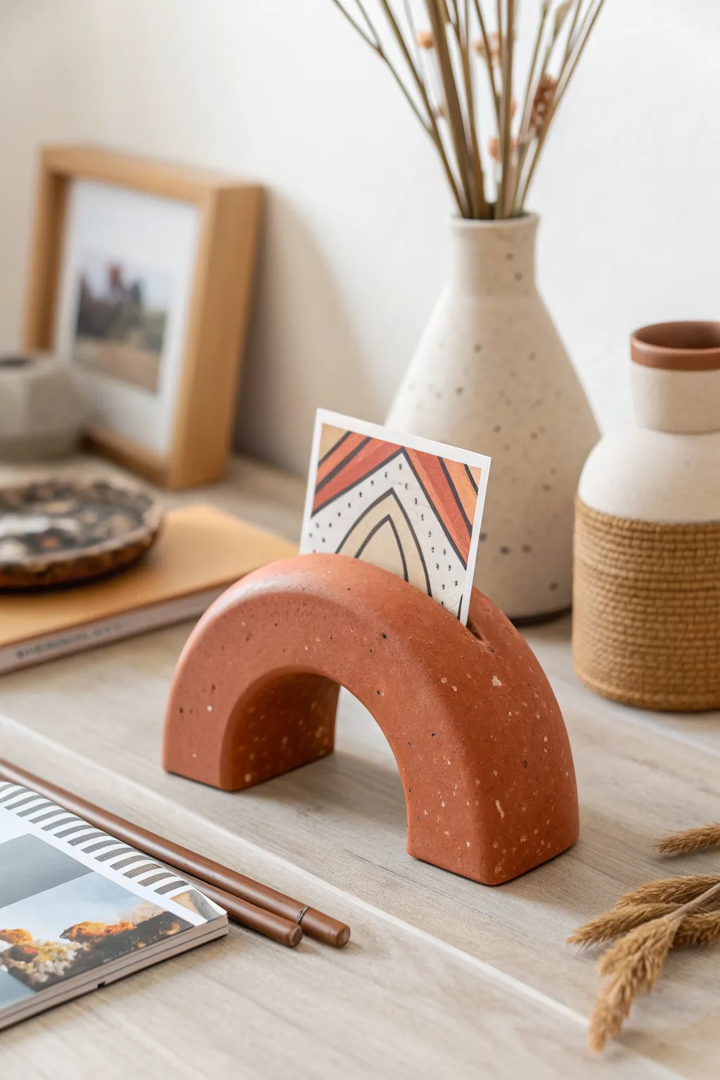 Minimal clay photo holder with clean slot, styled Scandinavian-boho for easy pottery inspiration.