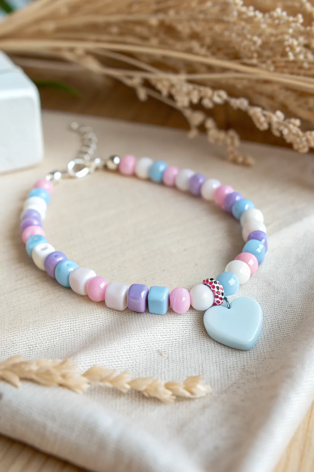 Candy-color clay bead bracelet with a glossy heart charm, pastel pink lilac and sky-blue pop