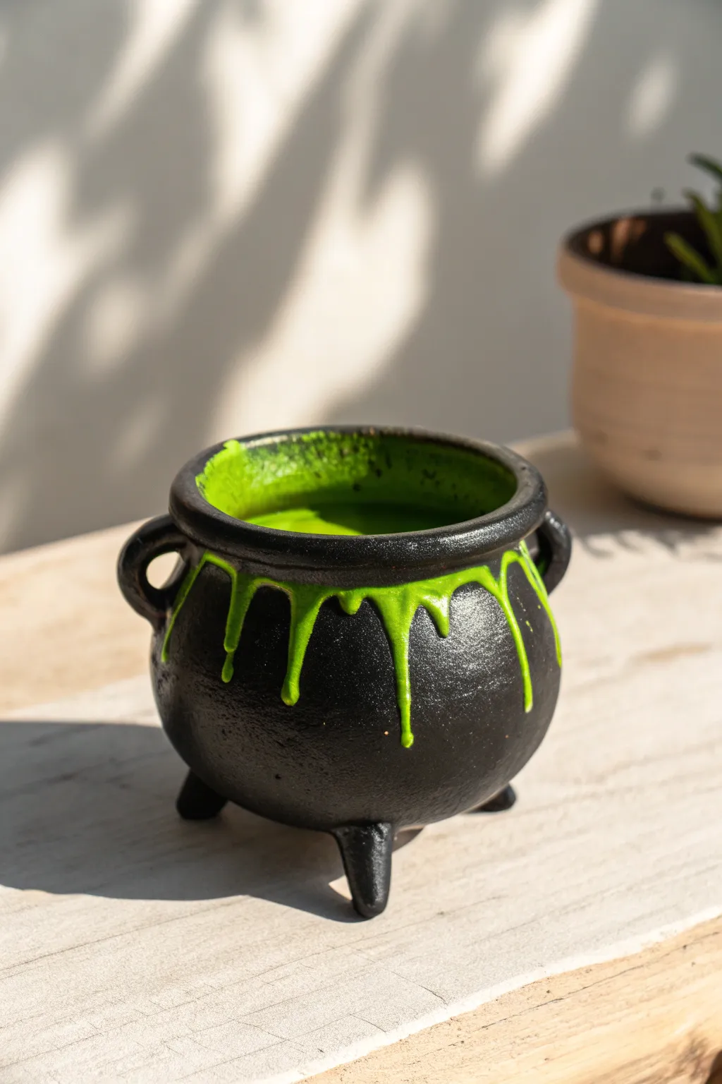 Spooky-cute witch cauldron mini planter with glossy green drips, minimalist Halloween charm.
