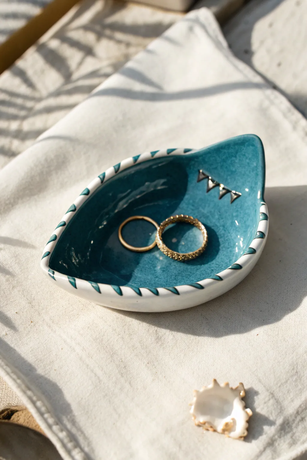 A bold teal shark bite trinket dish that keeps your rings safe in minimalist style.