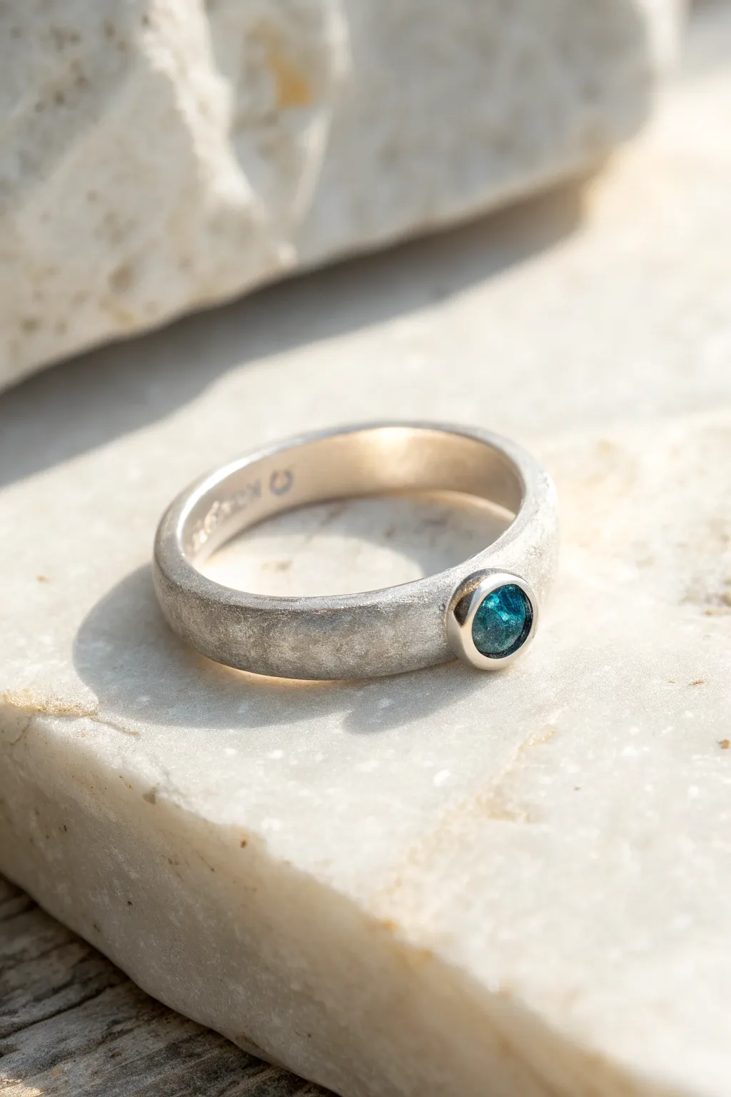 Simple silver clay band with a tiny teal fire-in-place stone, minimalist yet striking.
