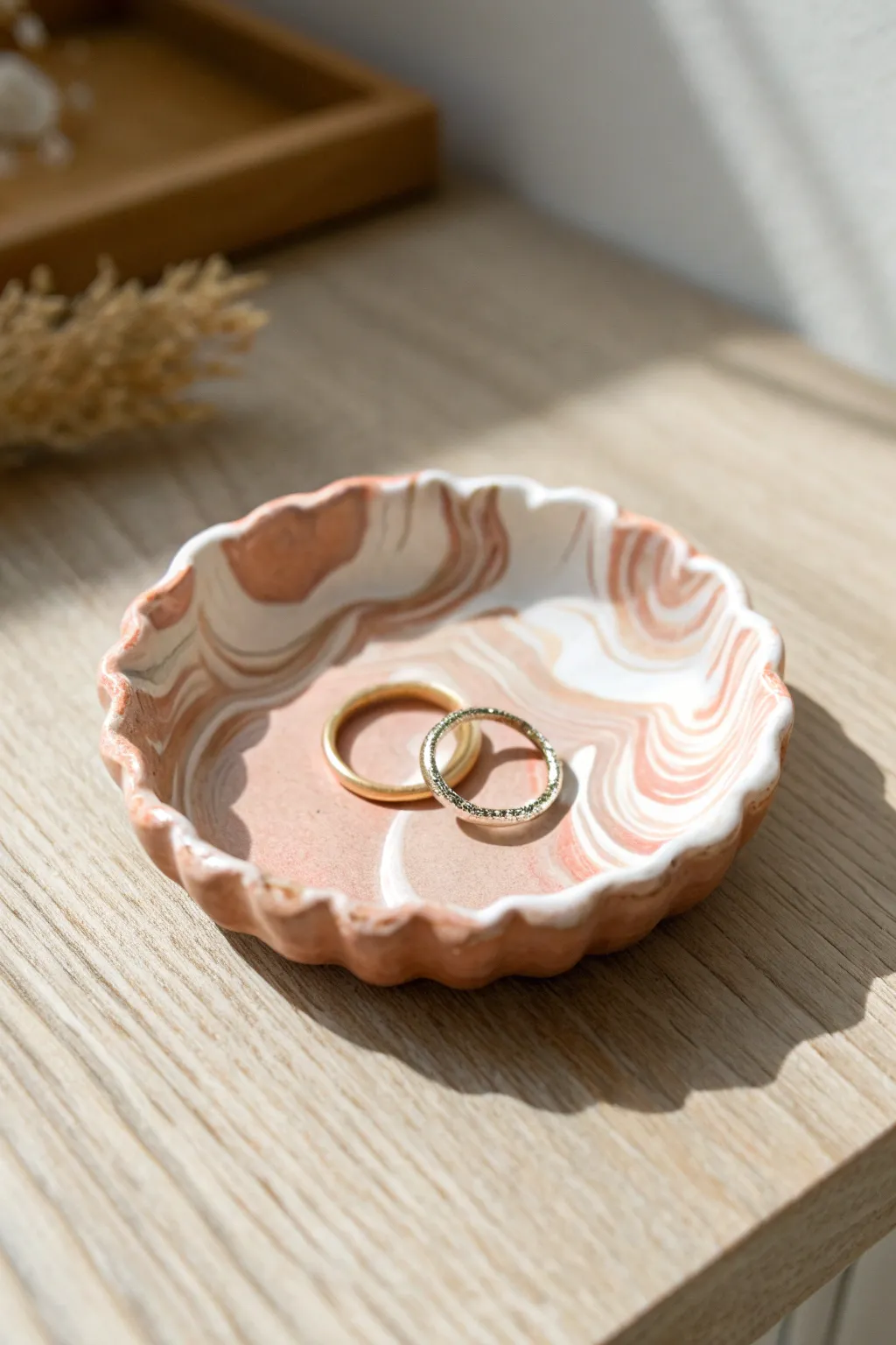 Minimal wavy polymer clay ring dish in warm marbled tones, styled with a few rings