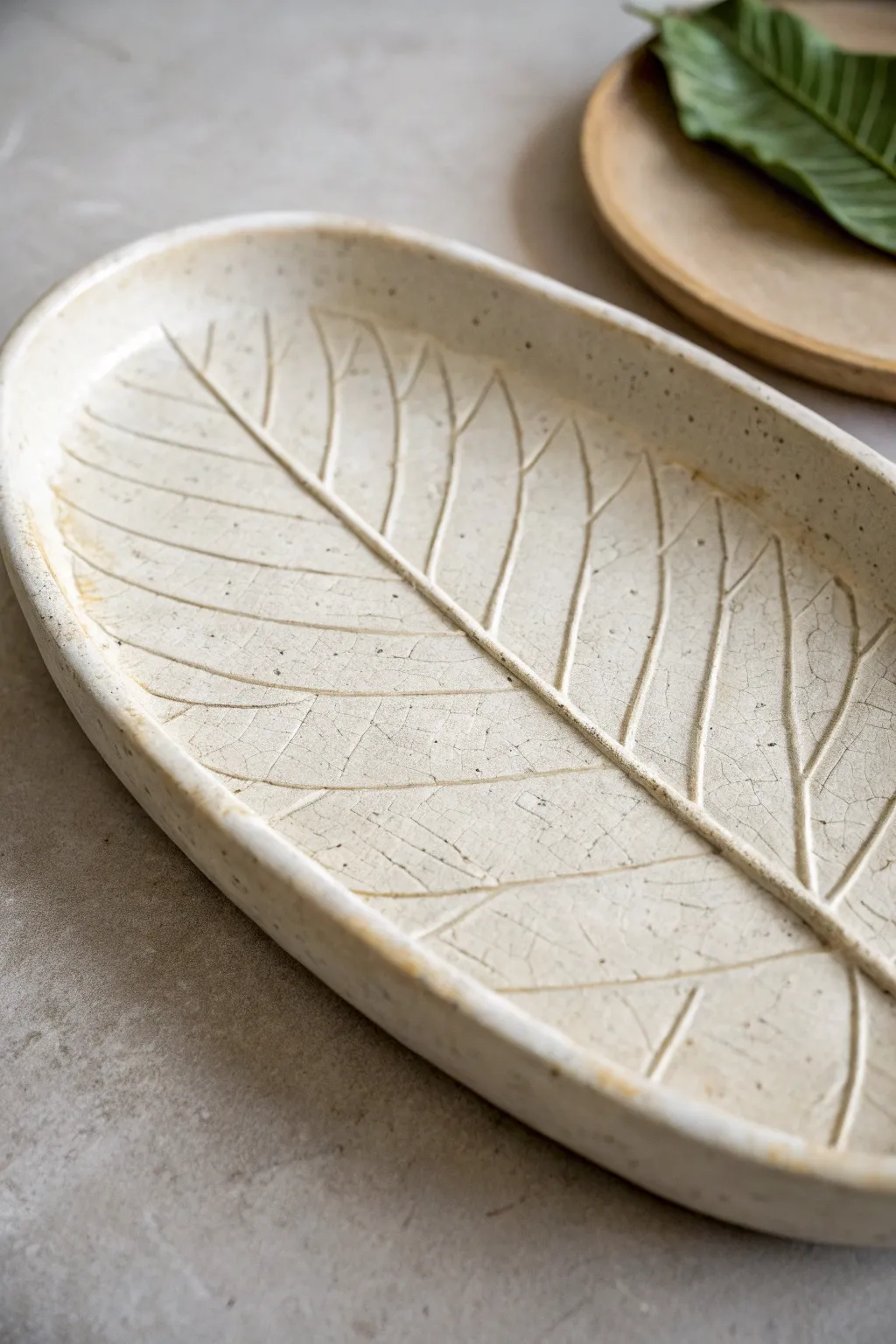 Leaf-imprint slab tray with a soft celadon glaze that makes every vein stand out beautifully.