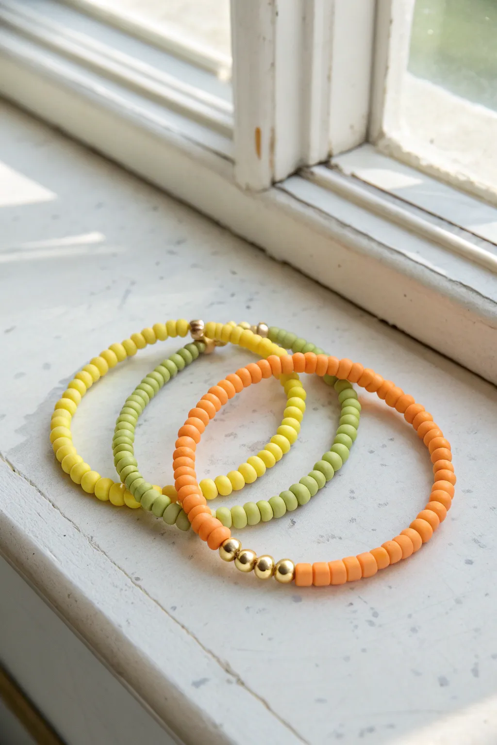 Bright citrus heishi clay bracelet trio in lemon, lime, and orange for easy summer stacking