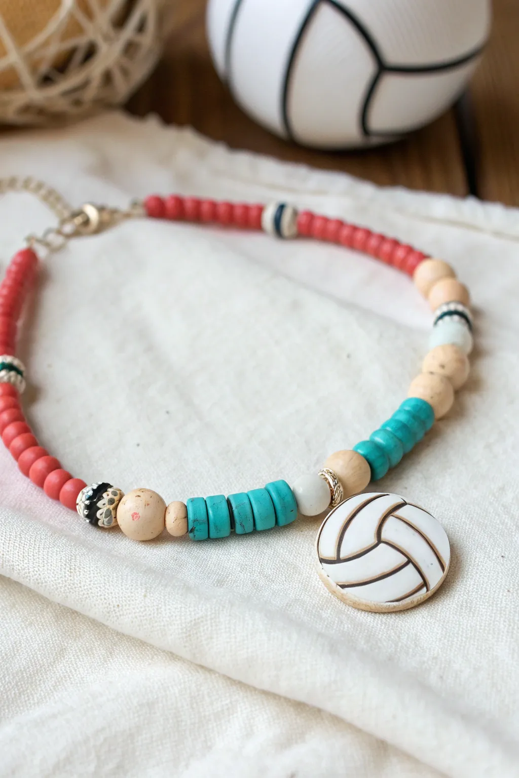 Bold clay heishi bracelet with a hand drawn volleyball net feature bead and a tiny volleyball charm